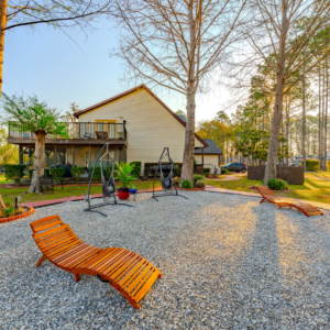 Outdoor shot of a lounge area with seating and hammocks next to the clubhouse at Lake City RV Resort