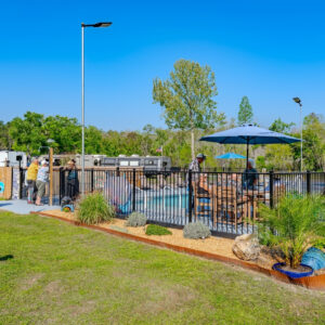 outdoor pool with patio furniture on a sunny day at Lake City RV Resort