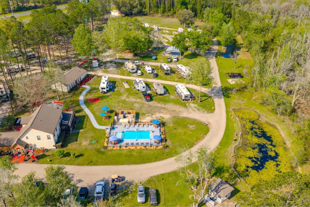 Aerial of Lake City RV Resort, featuring the outdoor pool and grounds, along with a handful of RV sites